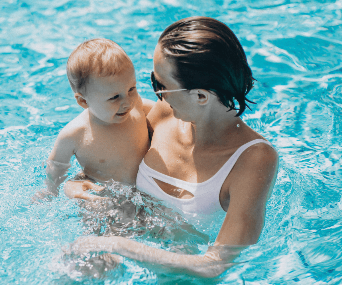 stock photo of a lady and a kid in a pool