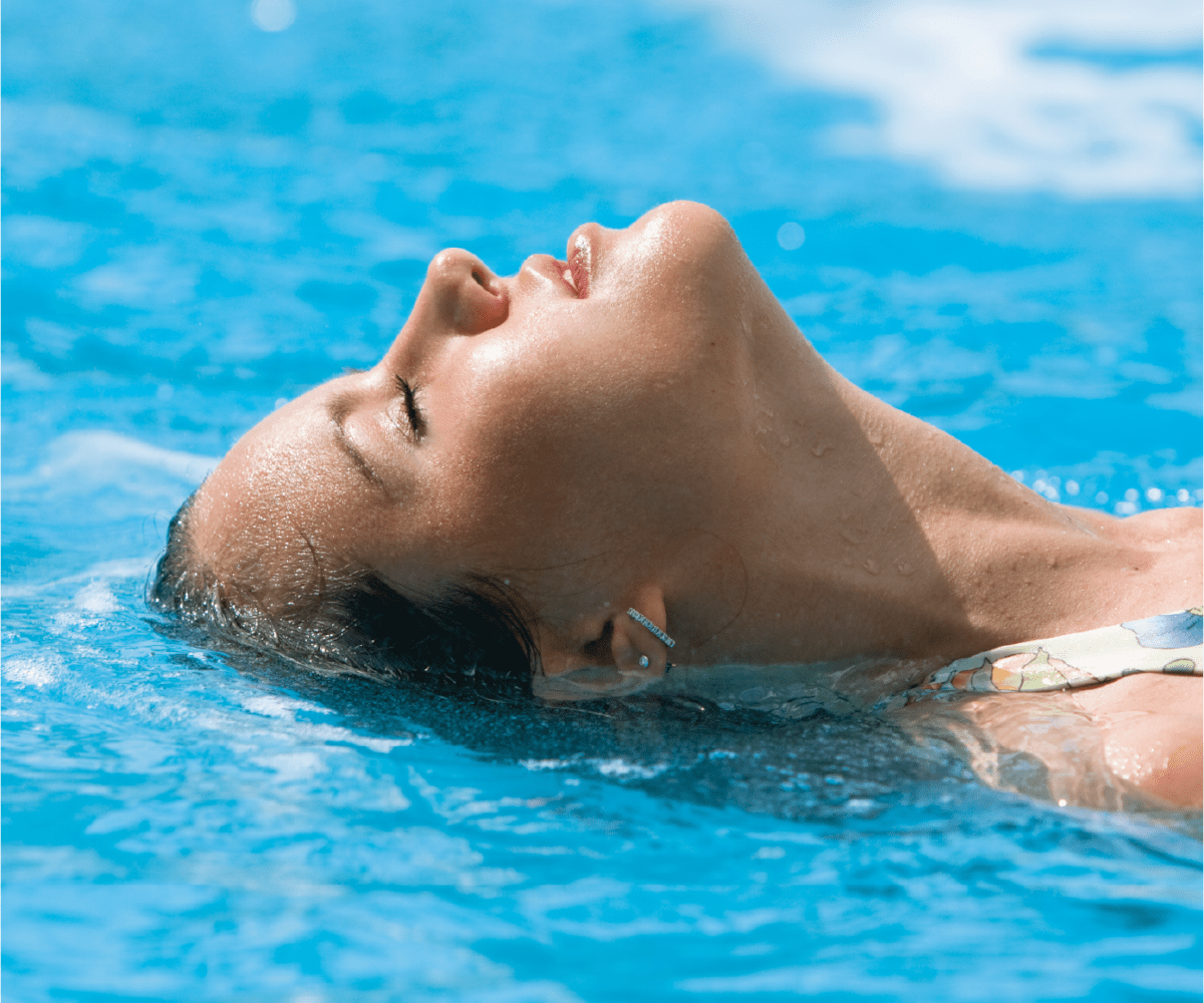 stock photo of lady floating on her back in a pool